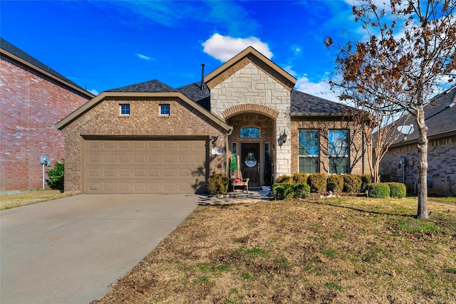 view of front of house featuring a garage and a front yard