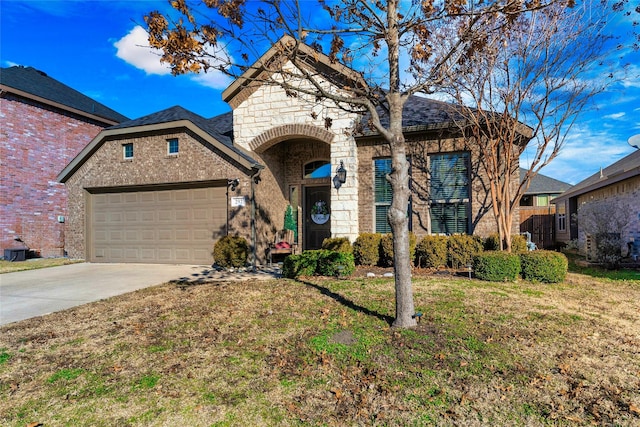 view of front of home featuring a garage and a front yard