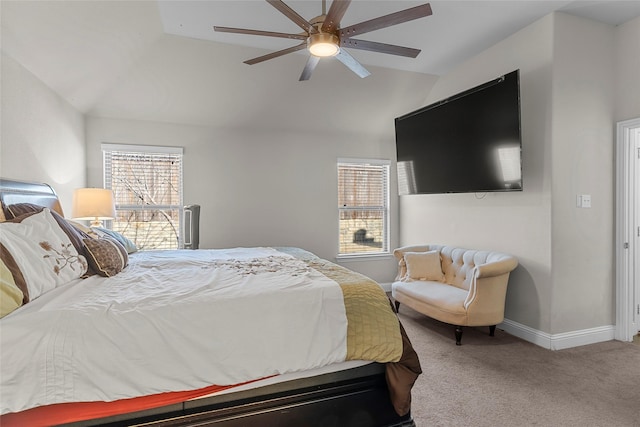 carpeted bedroom with ceiling fan, multiple windows, and lofted ceiling