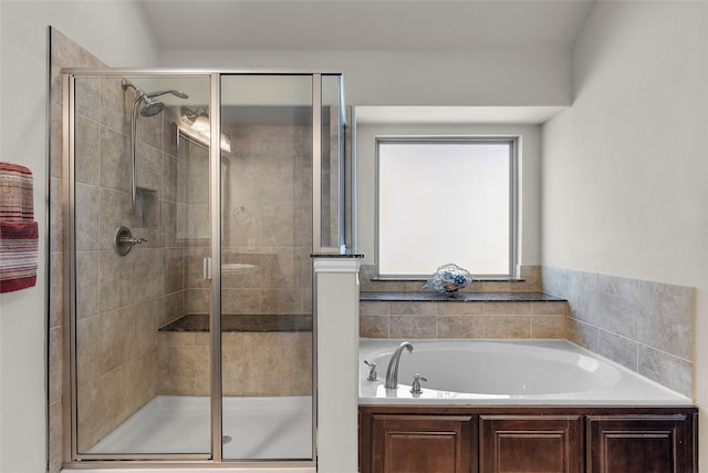 bathroom featuring shower with separate bathtub