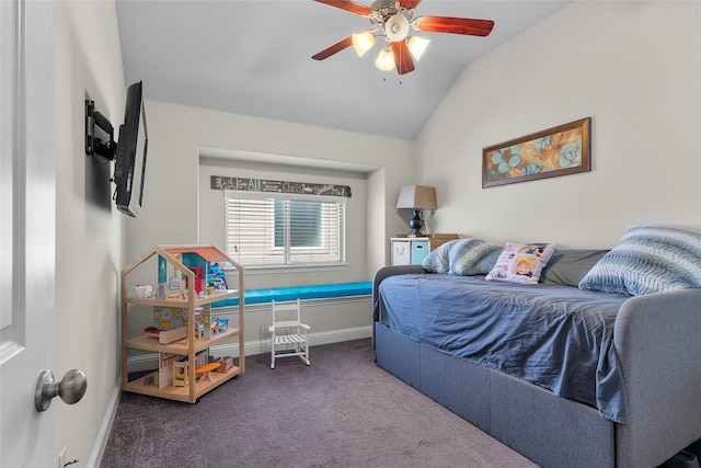 bedroom with ceiling fan, dark colored carpet, and vaulted ceiling