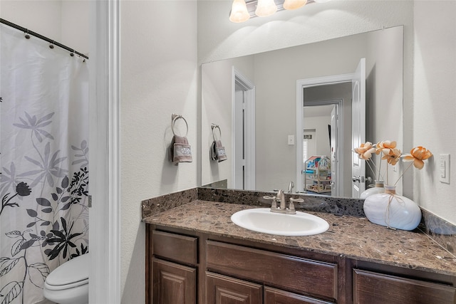 bathroom with toilet and vanity