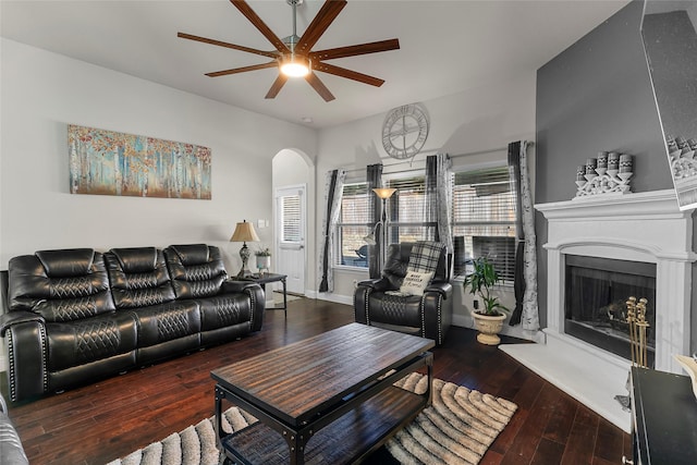 living room featuring dark wood-type flooring and ceiling fan