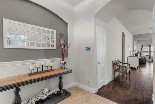 hall with light tile patterned flooring and ornamental molding