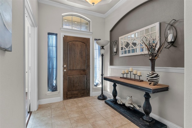 tiled entrance foyer featuring crown molding