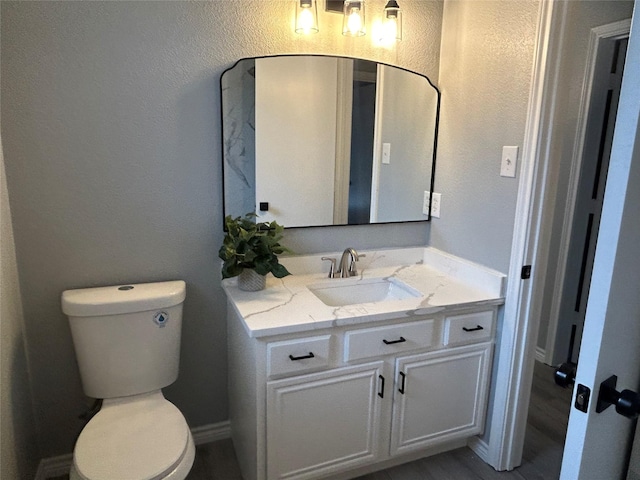 bathroom featuring toilet and vanity