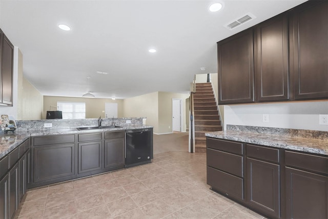 kitchen with black dishwasher, sink, light stone counters, and dark brown cabinetry