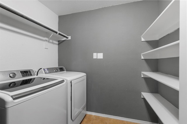 clothes washing area featuring separate washer and dryer and light wood-type flooring