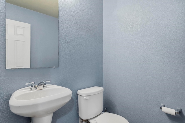 bathroom featuring sink and toilet