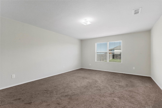 carpeted empty room with a textured ceiling