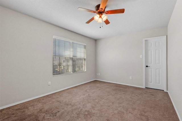 unfurnished room with ceiling fan, a textured ceiling, carpet flooring, and baseboards