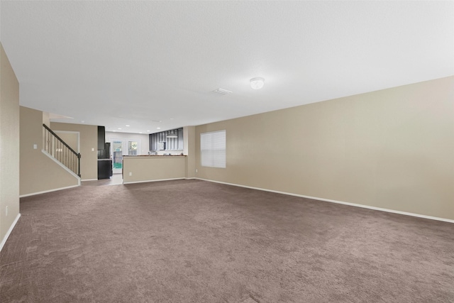 unfurnished living room with carpet