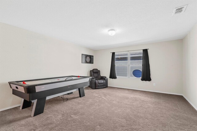 carpeted cinema room with a textured ceiling