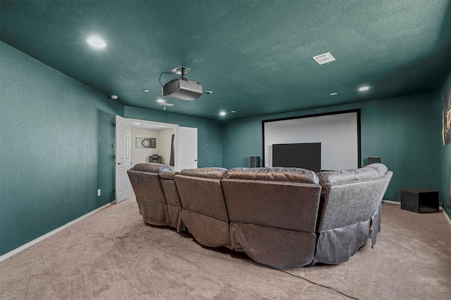 cinema room featuring a textured ceiling and carpet flooring