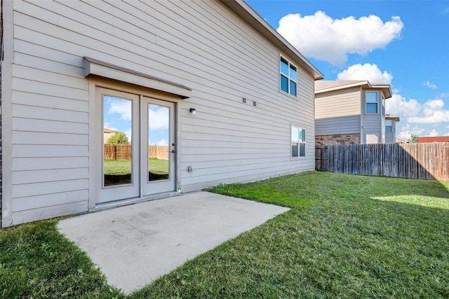 rear view of property featuring a patio and a lawn