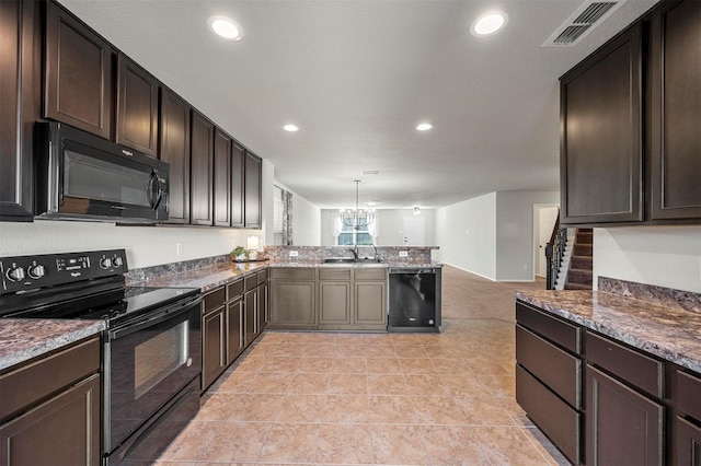 kitchen with a peninsula, a sink, visible vents, dark brown cabinets, and black appliances