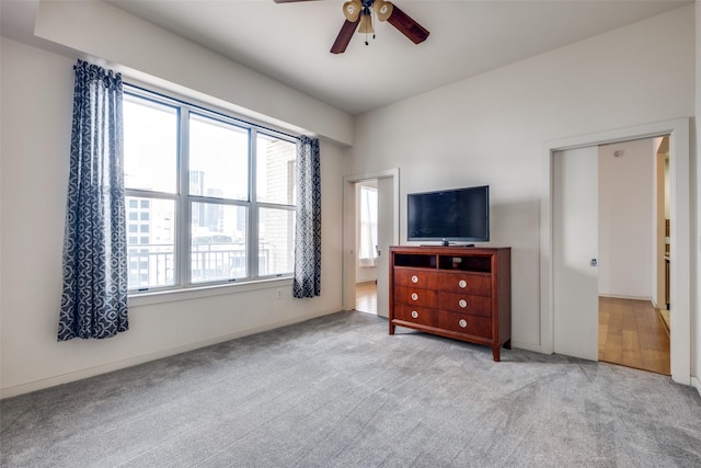 bedroom featuring light carpet and ceiling fan