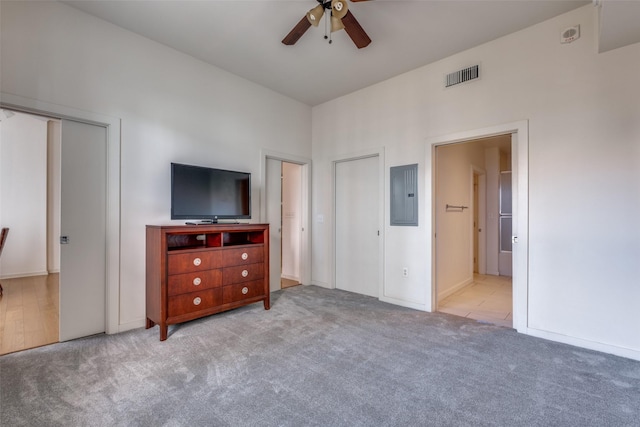 carpeted bedroom with ceiling fan, connected bathroom, and electric panel