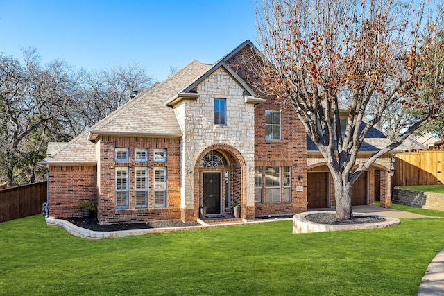 view of front of property with a garage and a front lawn