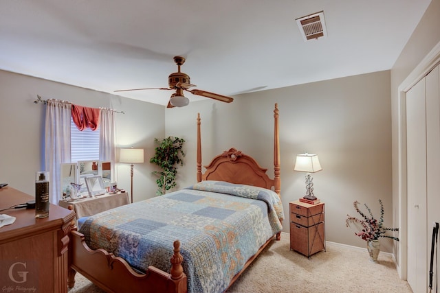 carpeted bedroom featuring ceiling fan and a closet