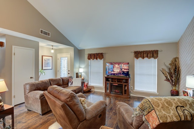 living room featuring lofted ceiling and hardwood / wood-style flooring