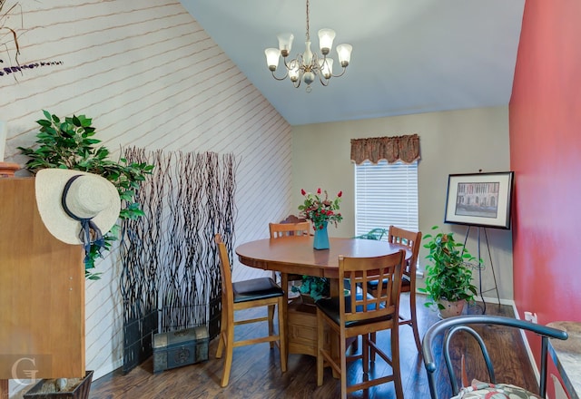 dining room featuring an inviting chandelier, dark hardwood / wood-style flooring, and lofted ceiling