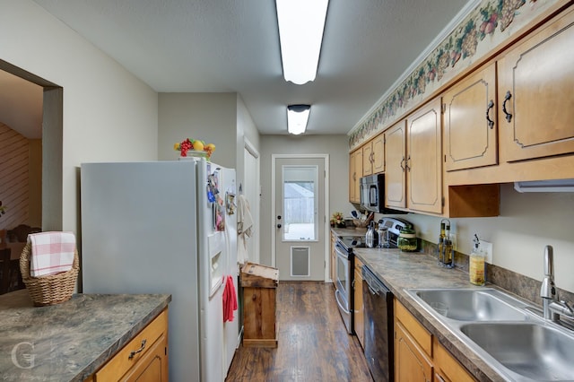 kitchen featuring black appliances, dark hardwood / wood-style floors, and sink