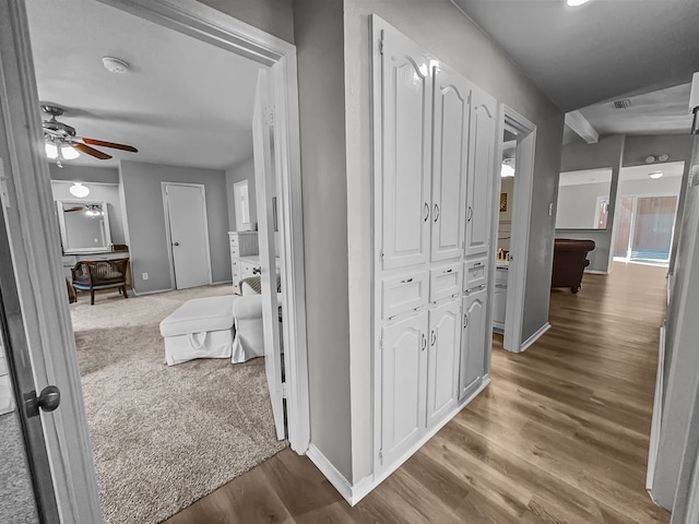 hallway with hardwood / wood-style flooring