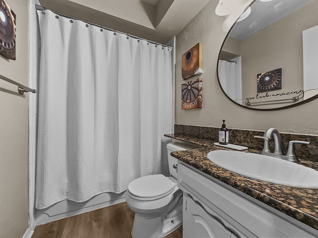 full bathroom featuring hardwood / wood-style floors, toilet, vanity, and shower / tub combo