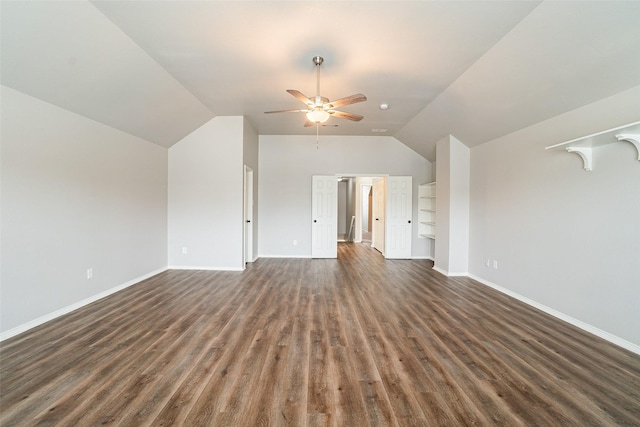 unfurnished living room with ceiling fan, dark wood-type flooring, and vaulted ceiling