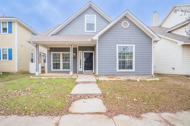 view of front of home featuring covered porch and a front yard