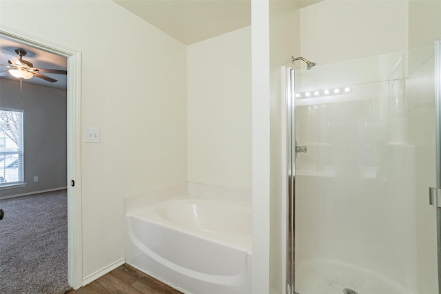 bathroom with hardwood / wood-style flooring and separate shower and tub