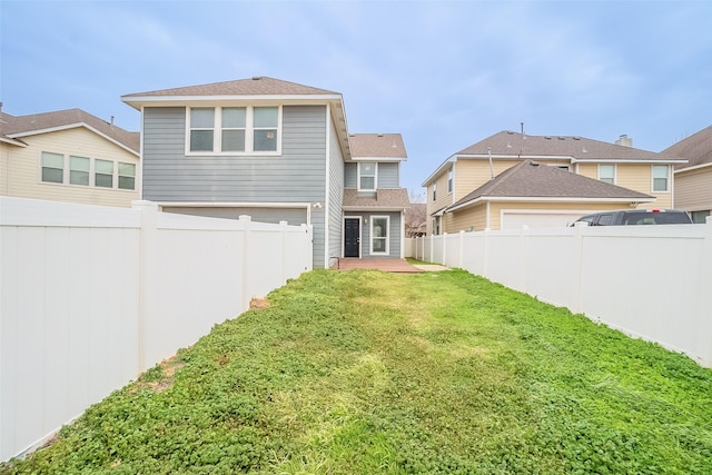 rear view of house with a yard and a patio