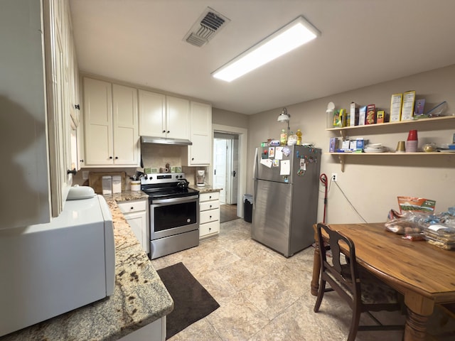 kitchen featuring light stone countertops, stainless steel appliances, and white cabinetry