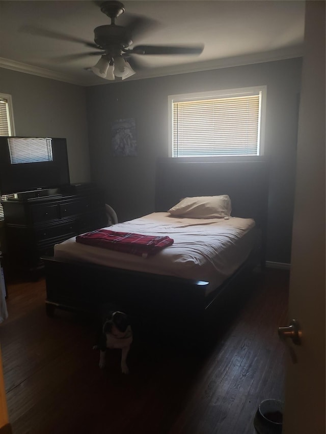 bedroom with ceiling fan, dark wood-type flooring, and ornamental molding