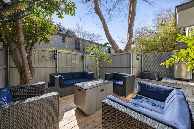 deck featuring central AC and an outdoor living space with a fire pit