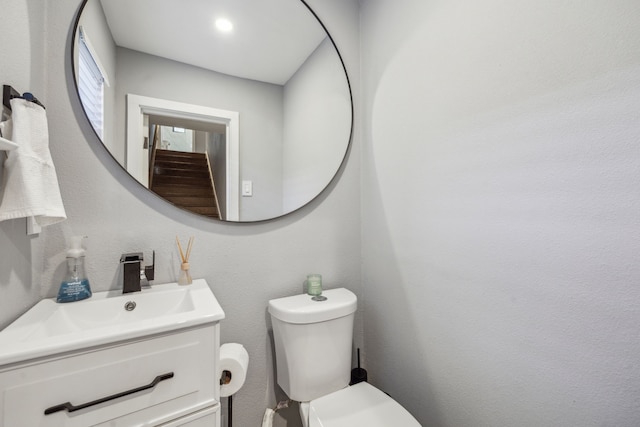 bathroom with toilet and vanity