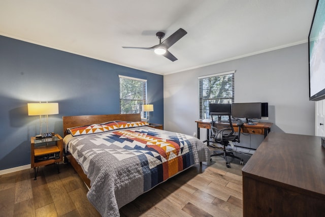 bedroom with ceiling fan, multiple windows, and hardwood / wood-style flooring