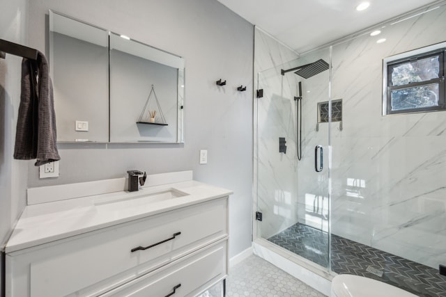 bathroom featuring toilet, a shower with shower door, tile patterned floors, and vanity