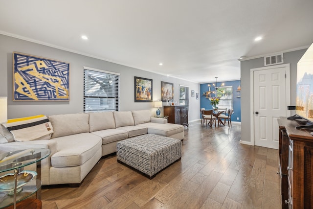 living room featuring crown molding and hardwood / wood-style floors