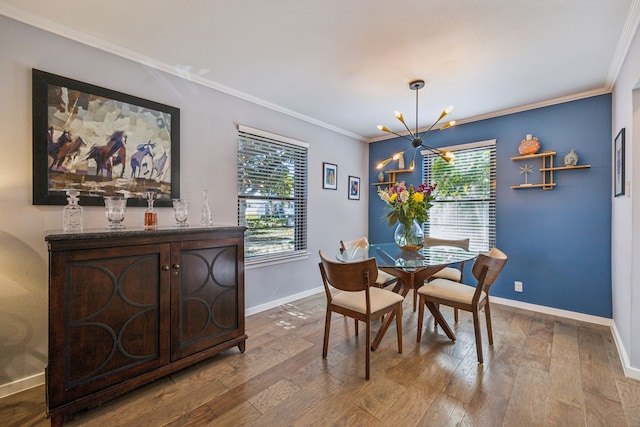 dining area featuring a notable chandelier, hardwood / wood-style flooring, and ornamental molding