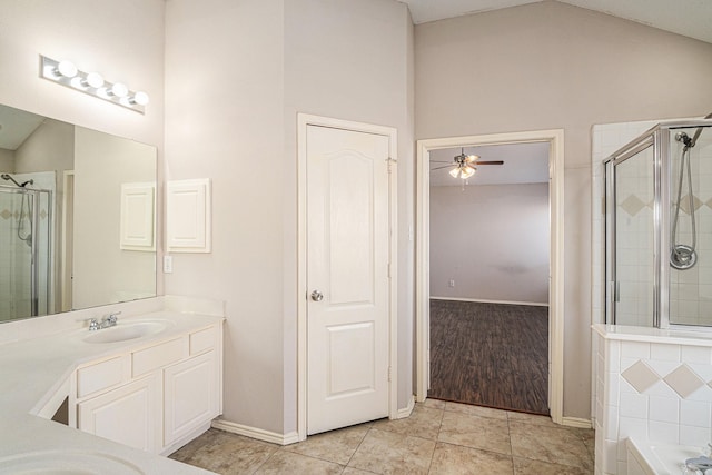 bathroom with tile patterned flooring, plus walk in shower, vaulted ceiling, and vanity