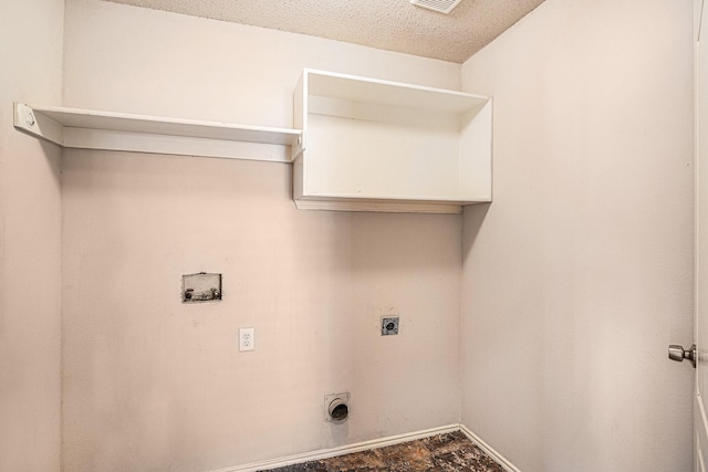 laundry room featuring electric dryer hookup, washer hookup, and a textured ceiling