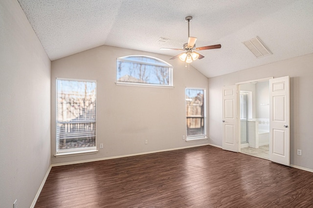 spare room with ceiling fan, a textured ceiling, vaulted ceiling, and wood-type flooring