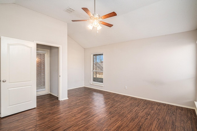 unfurnished bedroom with dark wood-type flooring, ceiling fan, and vaulted ceiling