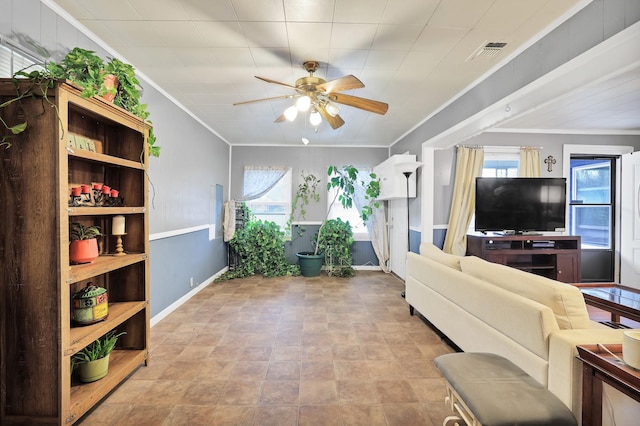 living room featuring ceiling fan and crown molding