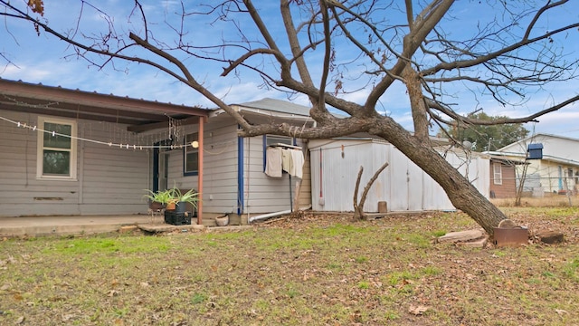 view of side of home with a yard