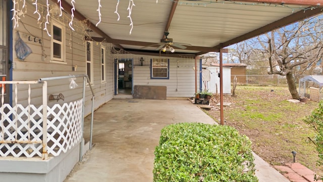 view of patio / terrace with ceiling fan and a storage shed