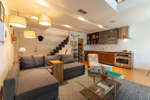 living room featuring light hardwood / wood-style floors and sink