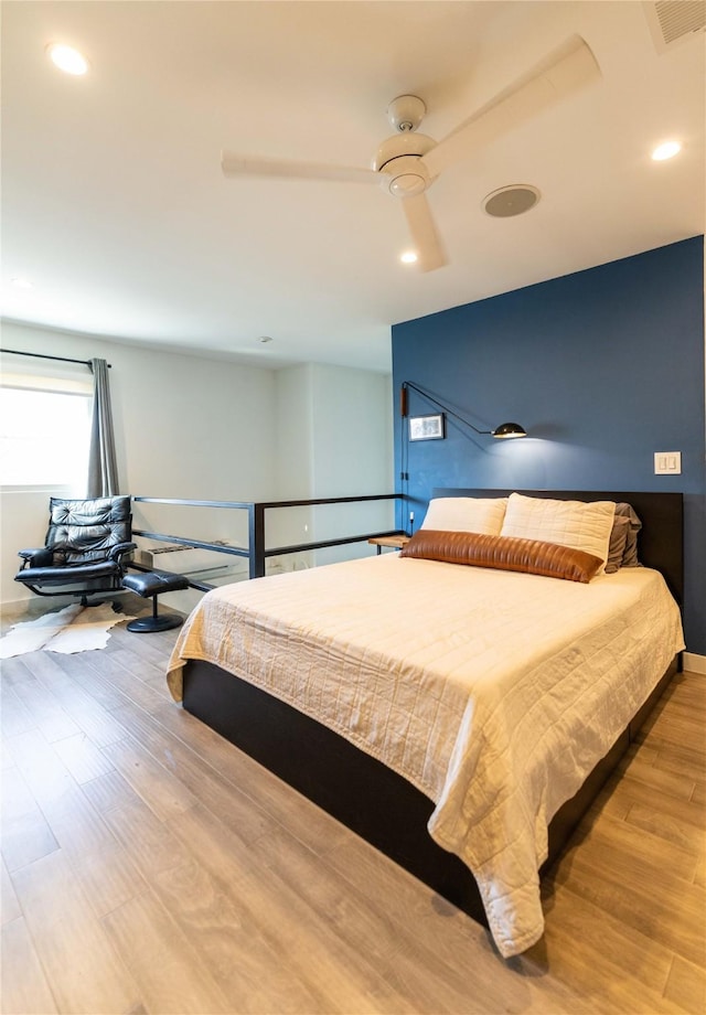 bedroom with ceiling fan and light hardwood / wood-style flooring